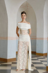 A long floral lace maxi dress in neutral tones with ribbon paneling and a flowing silhouette