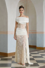 A long floral lace maxi dress in neutral tones with ribbon panelling details and a feminine silhouette