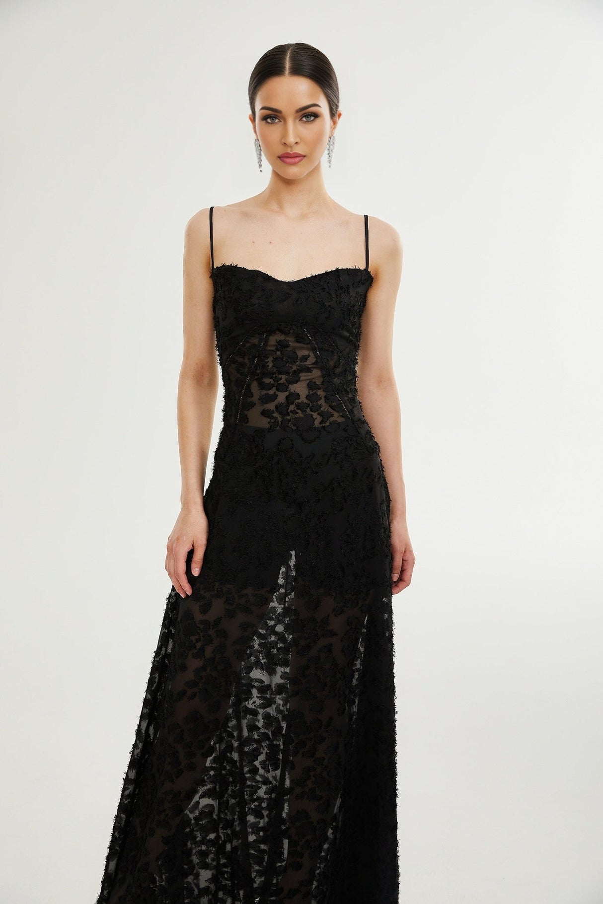 A long floral lace maxi dress with a feminine silhouette featuring delicate floral patterns and a floor length design