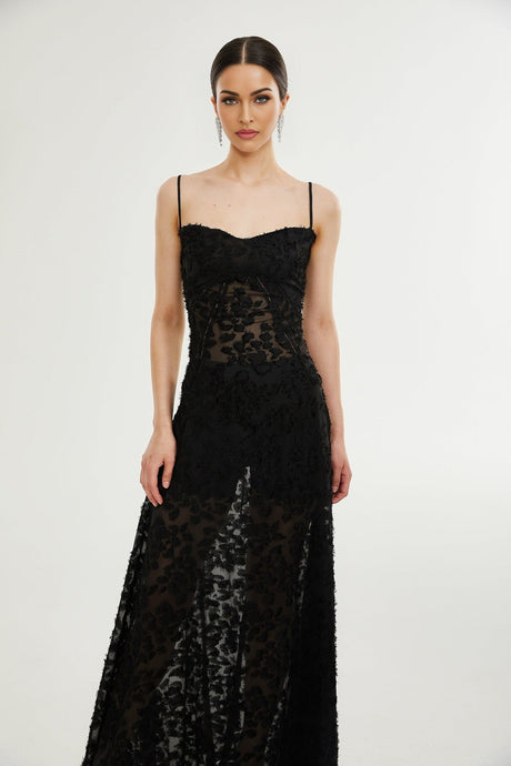 A long floral lace maxi dress with a feminine silhouette featuring delicate floral patterns and a floor length design