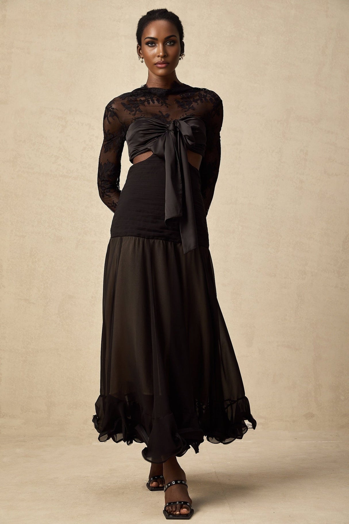 A long floral lace maxi dress with contrasting panels designed by Maïwenn featuring a feminine and elegant silhouette