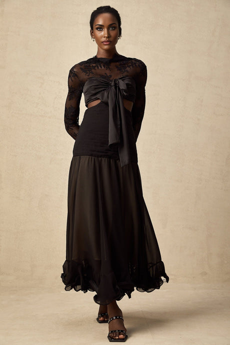 A long floral lace maxi dress with contrasting panels designed by Maïwenn featuring a feminine and elegant silhouette