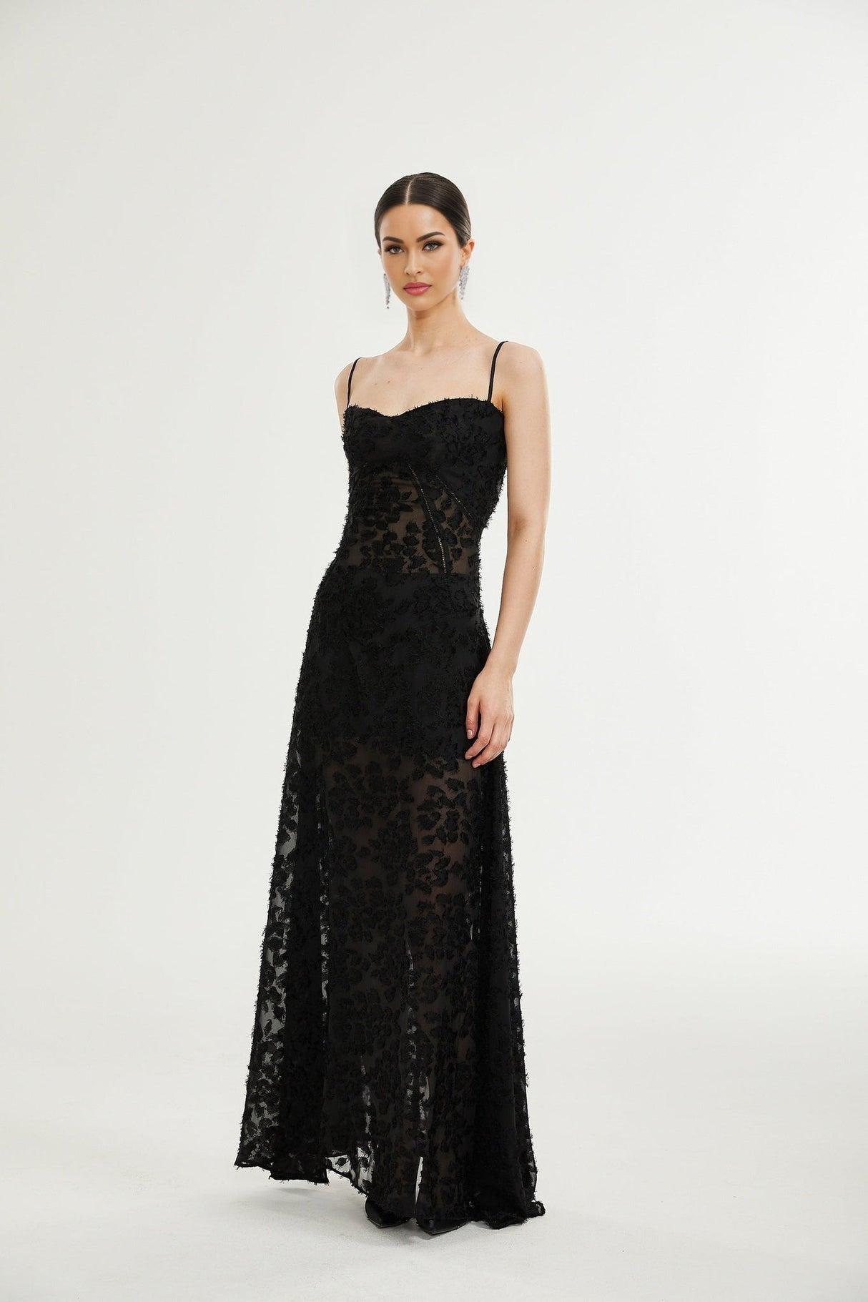 A long floral lace maxi dress with delicate pattern and feminine silhouette