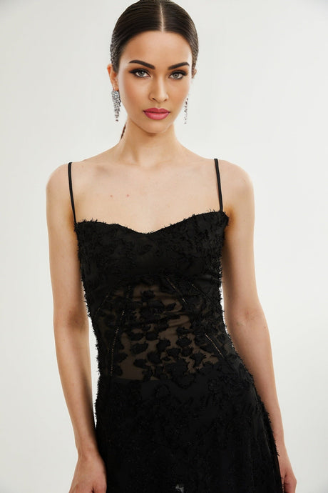 A long floral lace maxi dress with delicate pattern details and flowing silhouette