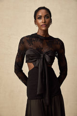 A long floral lace maxi dress with sheer panels and intricate detailing