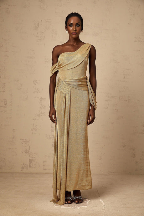 A long flowing golden maxi dress with gathered fabric and ribbon design details
