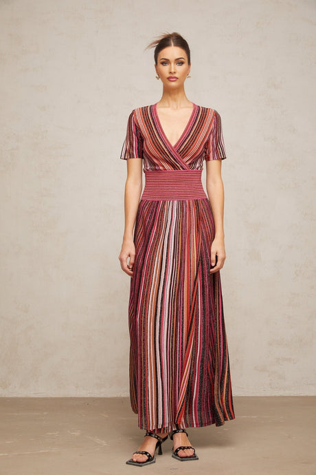 A long flowing maxi dress with a multicolor metallic knit pattern showcasing shimmering threads in various hues