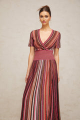 A long flowing maxi dress with a multicolored metallic knit pattern featuring various shimmering hues