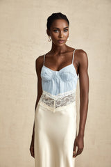 A long flowing maxi dress with lace trim details and panelled design in a light color