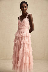 A long flowing maxi dress with layered ruffles made of tulle fabric featuring a romantic and ethereal design