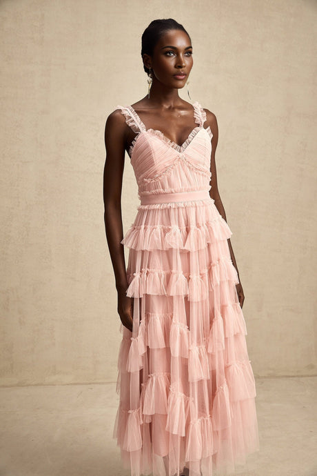 A long flowing maxi dress with multiple layers of ruffled tulle fabric creating a romantic and ethereal look