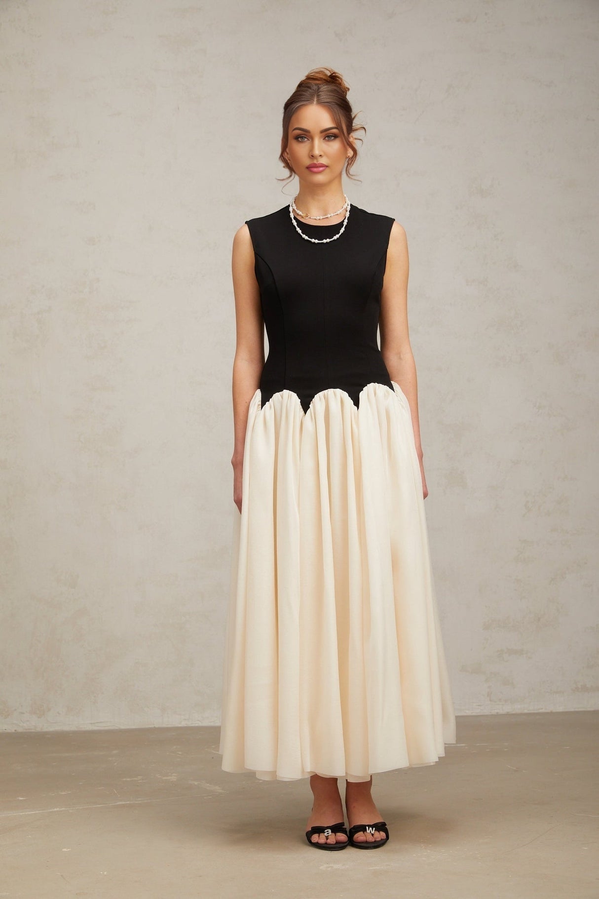 A long flowing maxi dress with puffed sleeves featuring colorblocked sections in contrasting hues named Josette