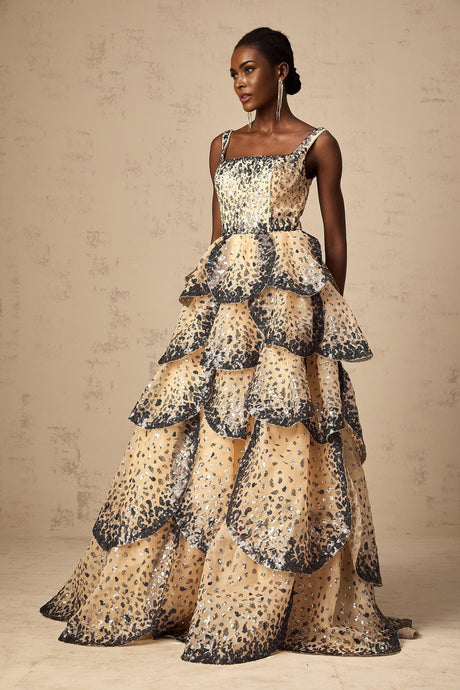 A long flowing maxi dress with tiered layers featuring shimmering sequin embellishments in a petal design