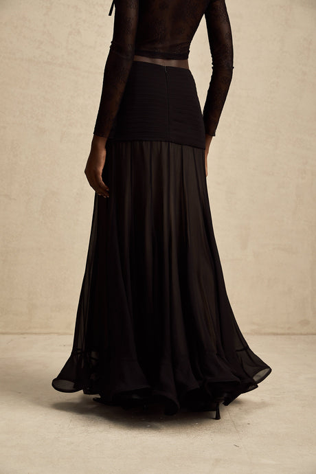 A long flowing maxi skirt with ruffles and pleats made of rayon and tulle fabric in a Jacqueline style