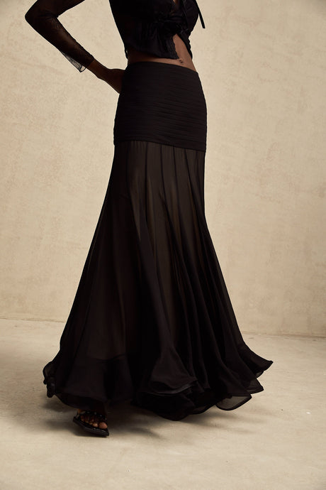 A long flowing maxi skirt with ruffles and pleats made of rayon and tulle fabric in a Jacqueline style