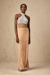 A long flowing white semi sheer maxi dress adorned with small faux pearl embellishments throughout