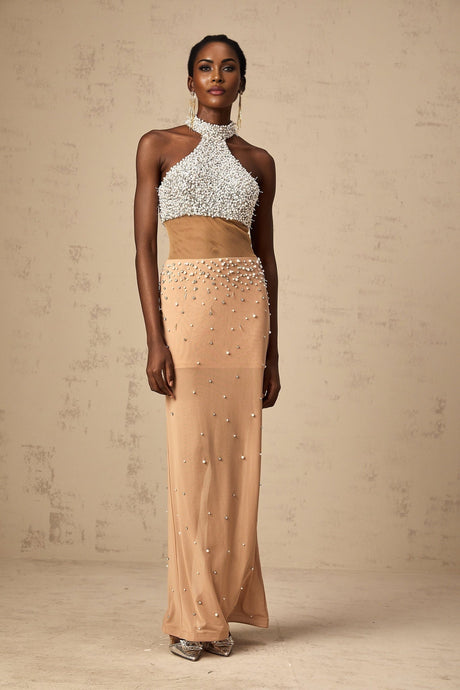 A long flowing white semi sheer maxi dress adorned with small faux pearl embellishments throughout