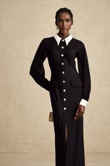 A long flowy maxi dress in contrasting colors with semisheer fabric details