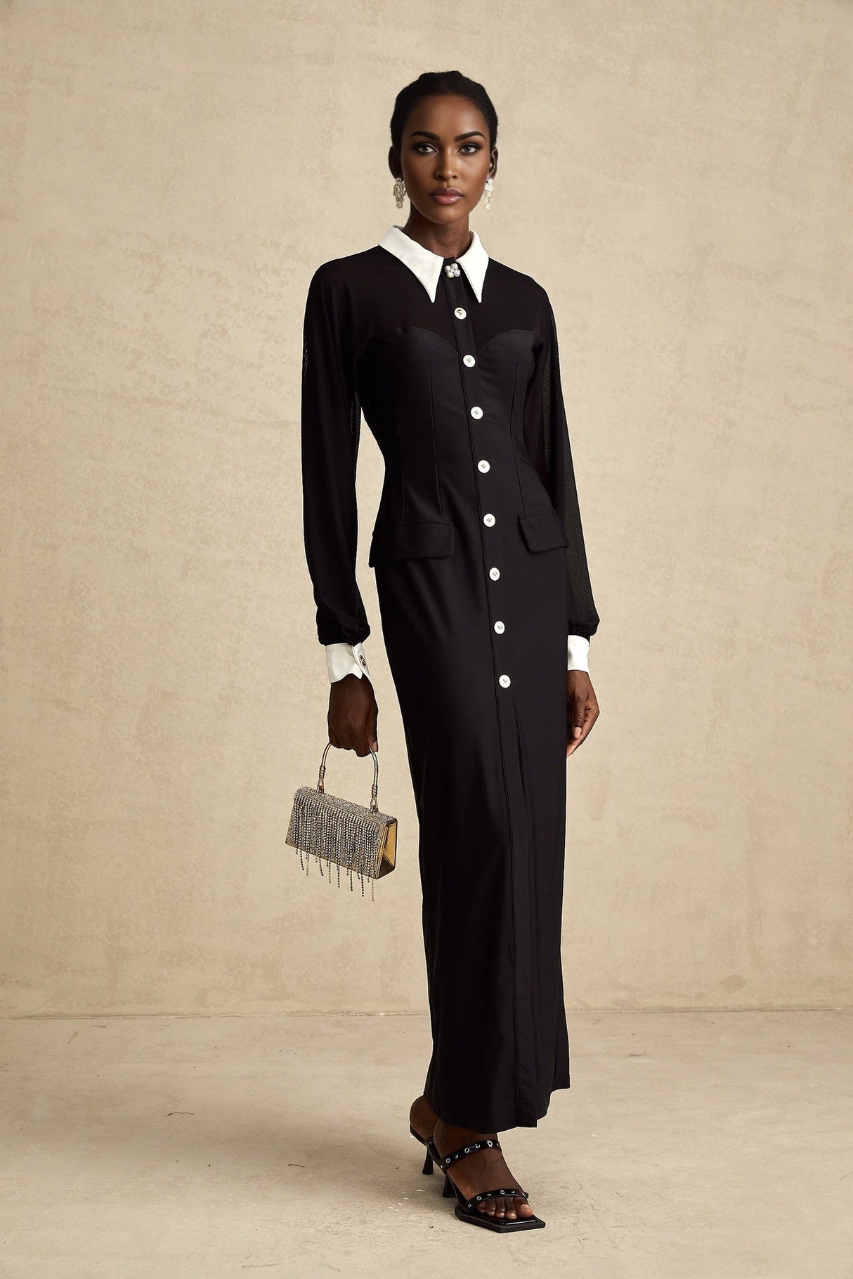 A long flowy maxi dress with contrasting colors and semisheer fabric featuring a feminine silhouette and lightweight design