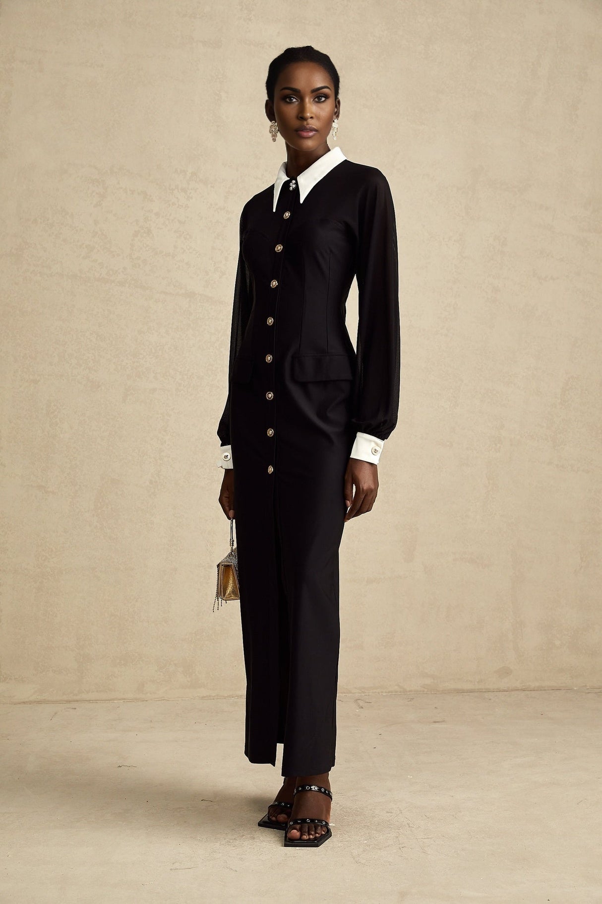 A long flowy maxi dress with contrasting colors and semisheer fabric featuring a feminine silhouette