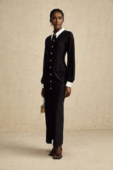 A long flowy maxi dress with contrasting colors and semisheer fabric featuring a feminine silhouette