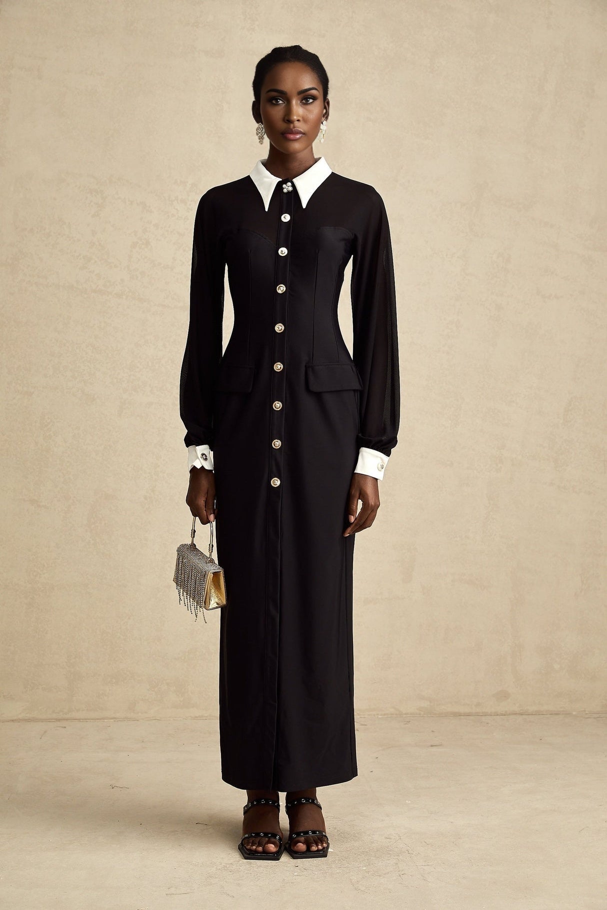 A long flowy maxi dress with contrasting colors and semisheer fabric featuring a lightweight and airy design