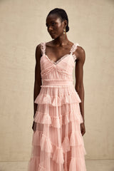 A long flowy maxi dress with multiple layers of ruffled tulle fabric creating a romantic and ethereal look