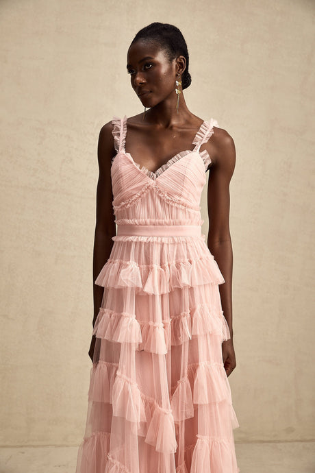 A long flowy maxi dress with multiple layers of ruffled tulle fabric creating a romantic and ethereal look