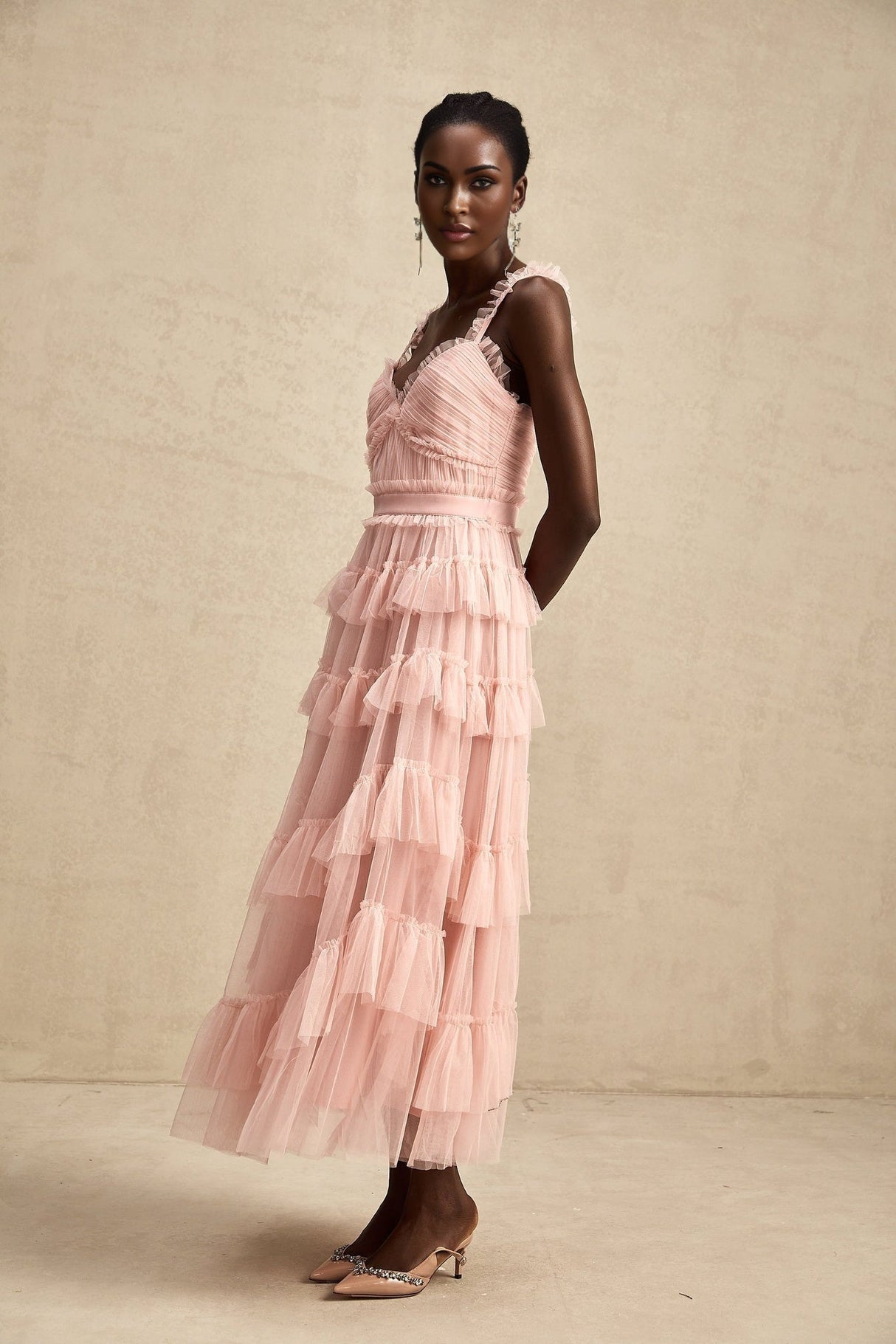 A long flowy maxi dress with multiple layers of ruffled tulle fabric creating a romantic and ethereal look