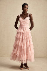 A long flowy maxi dress with multiple layers of ruffled tulle fabric creating a romantic and ethereal look