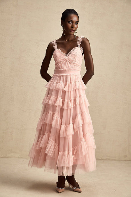 A long flowy maxi dress with multiple layers of ruffled tulle fabric creating a romantic and ethereal look