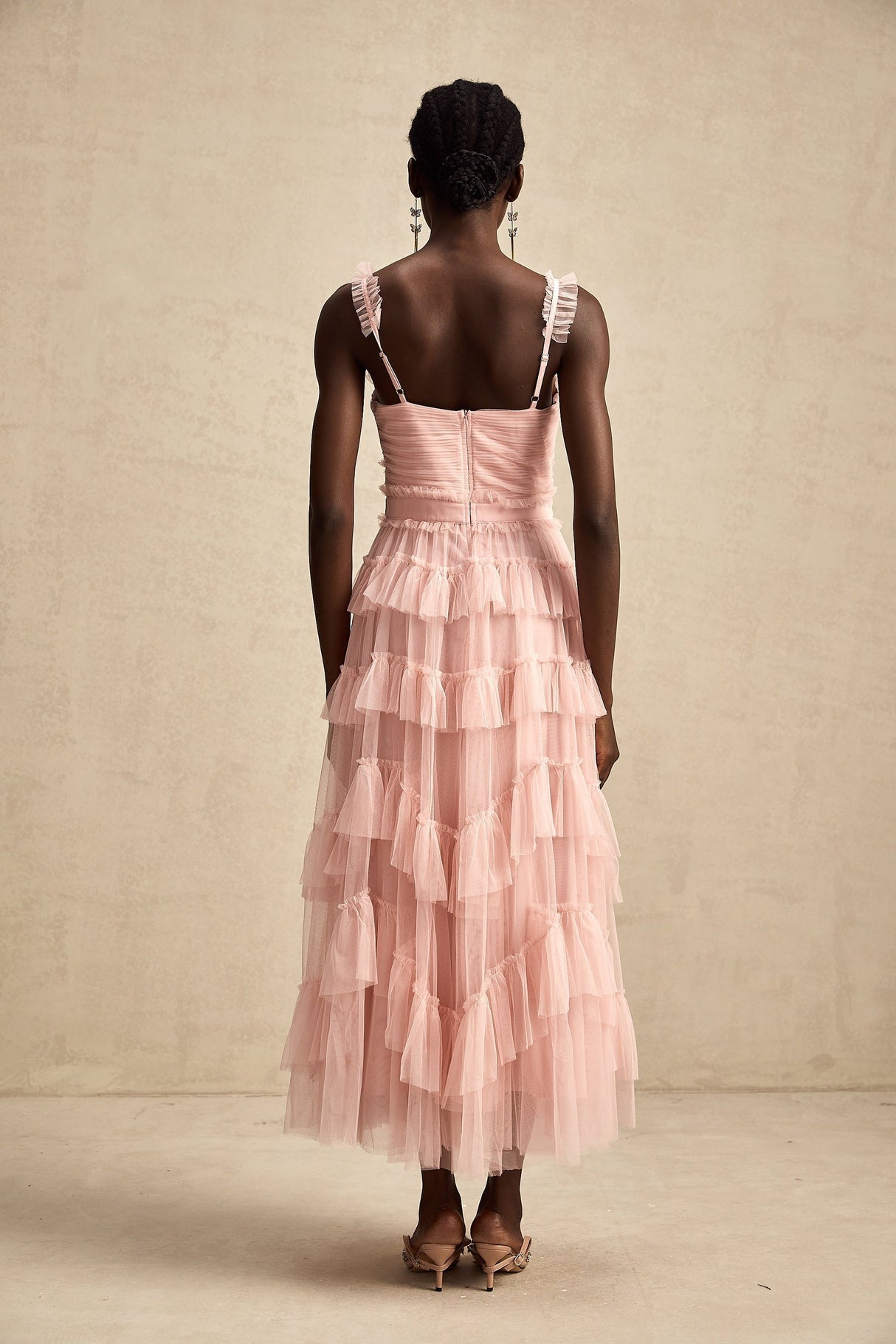 A long flowy maxi dress with multiple layers of ruffled tulle fabric creating a romantic and ethereal look