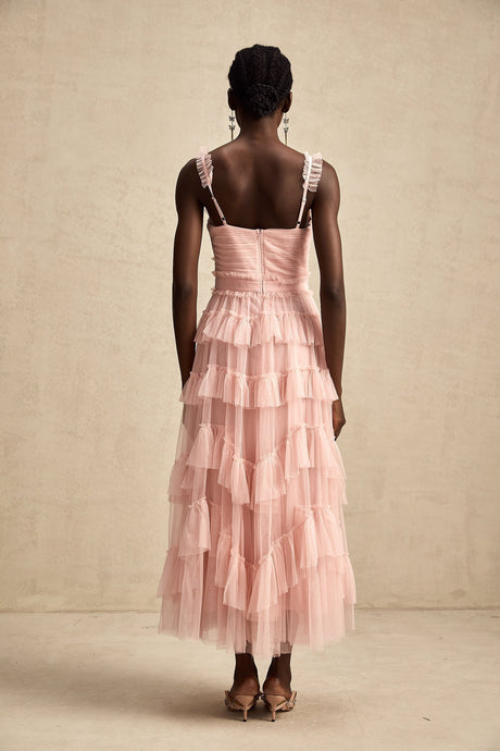 A long flowy maxi dress with multiple layers of ruffled tulle fabric creating a romantic and ethereal look