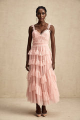 A long flowy maxi dress with multiple layers of ruffled tulle fabric creating a romantic and ethereal look