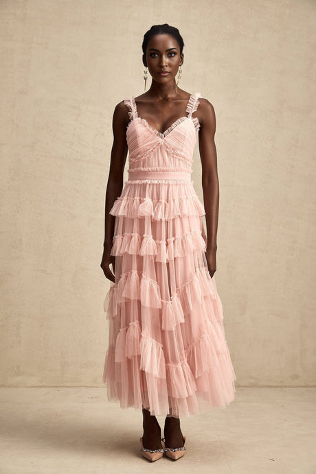 A long flowy maxi dress with multiple layers of ruffled tulle fabric creating a romantic and ethereal look