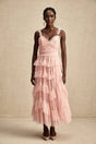 A long flowy maxi dress with multiple layers of ruffled tulle fabric creating a romantic and ethereal look