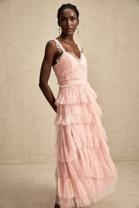 A long flowy maxi dress with multiple layers of ruffled tulle fabric creating a romantic and ethereal silhouette