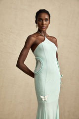 A long flowy maxi dress with ruffle details and a butterfly print pattern named Amelie