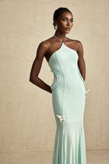 A long flowy maxi dress with ruffled details and a butterfly pattern featuring a feminine silhouette and romantic design elements