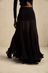 A long flowy maxi skirt in pale colors with ruffles and pleats made of rayon and tulle fabric