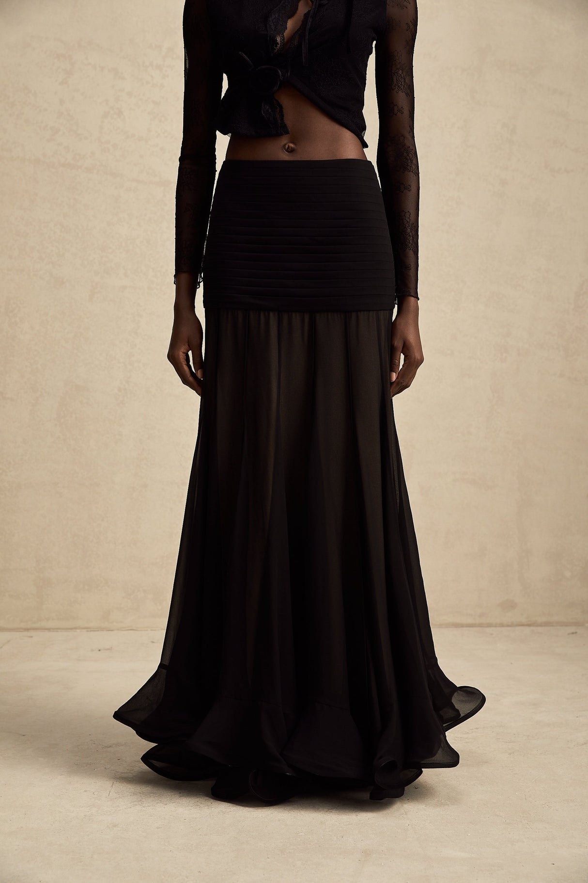 A long flowy maxi skirt with ruffles and pleats made from rayon and tulle fabric in a light airy style