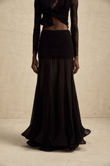 A long flowy maxi skirt with ruffles and pleats made from rayon and tulle fabric in a light airy style