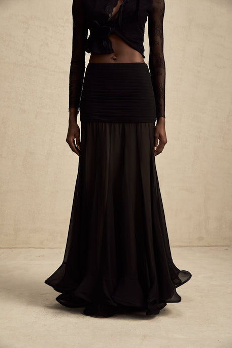 A long flowy maxi skirt with ruffles and pleats made from rayon and tulle fabric in a light airy style