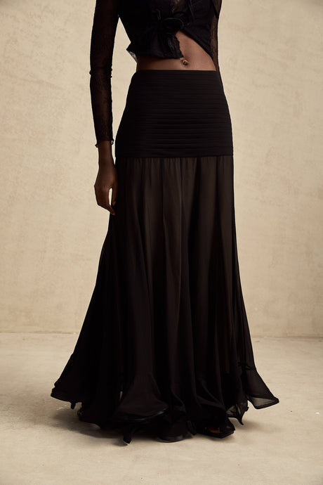 A long flowy maxi skirt with ruffles and pleats made of rayon and tulle fabric in a light feminine style