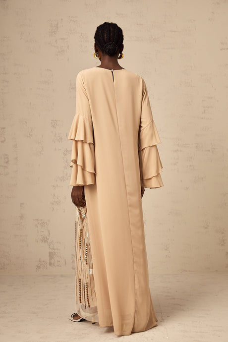 A long formal maxi dress with sequin embellishments ruffle sleeves and tulle fabric in a flowing silhouette
