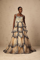 A long formal maxi dress with tiered layers of sequined petals cascading down the length creating a shimmering floral effect