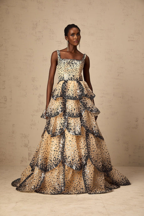 A long formal maxi dress with tiered layers of sequined petals cascading down the length creating a shimmering floral effect