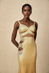 A long gold maxi dress with floral cutout details and a flowing silhouette named Giulia