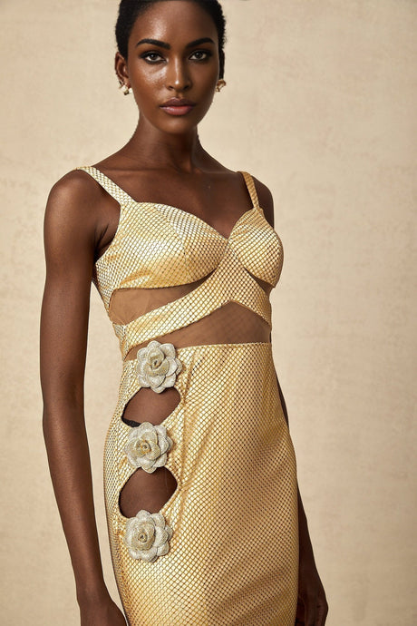 A long gold maxi dress with floral cutout details and a sleek silhouette suitable for formal occasions