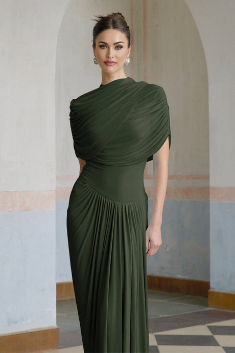 A long green asymmetric maxi dress with pleats and a flowing silhouette